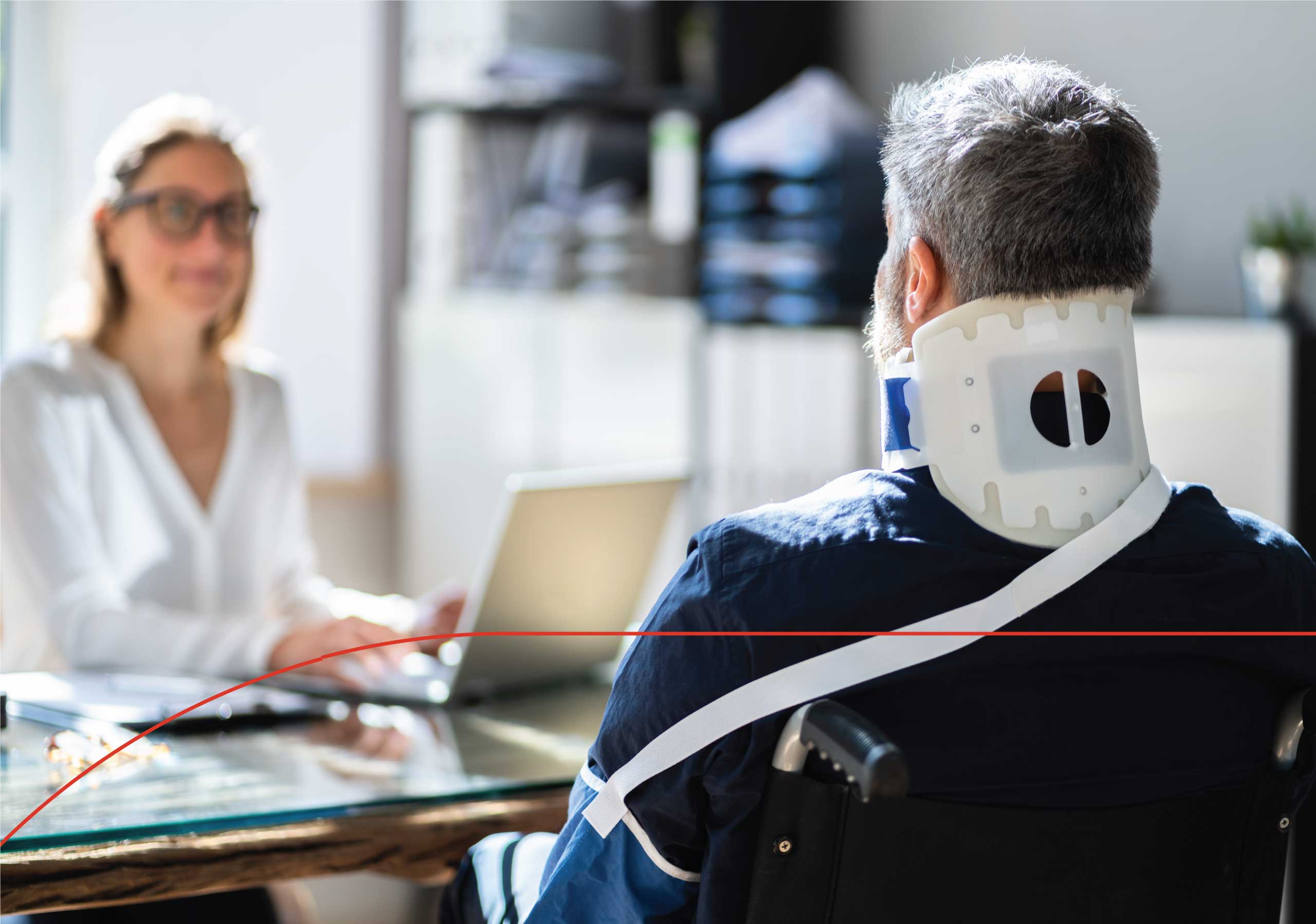 Male sitting in a wheelchair with neck brace speaking to their representative about workers's compensation claim