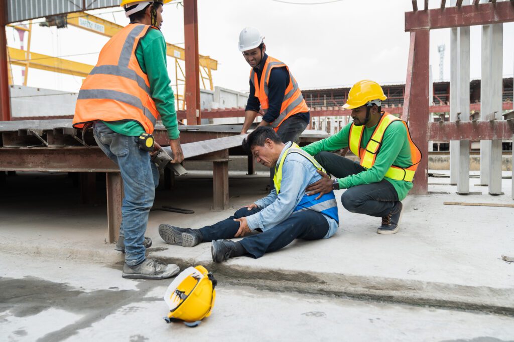 Asian male worker accident at his leg at construction site. Industrial accident concept