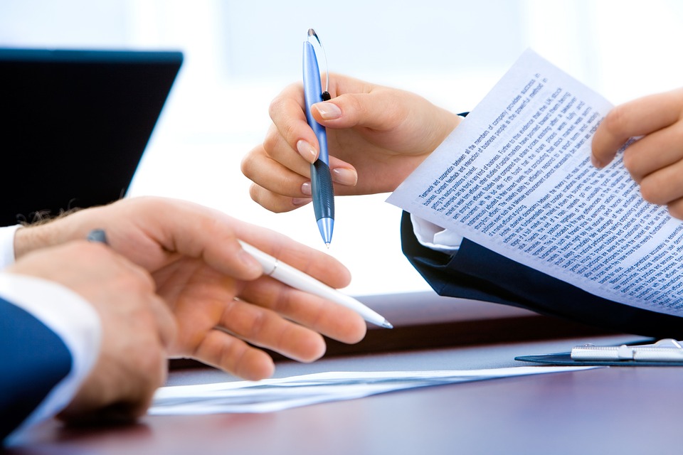 Business people signing documents