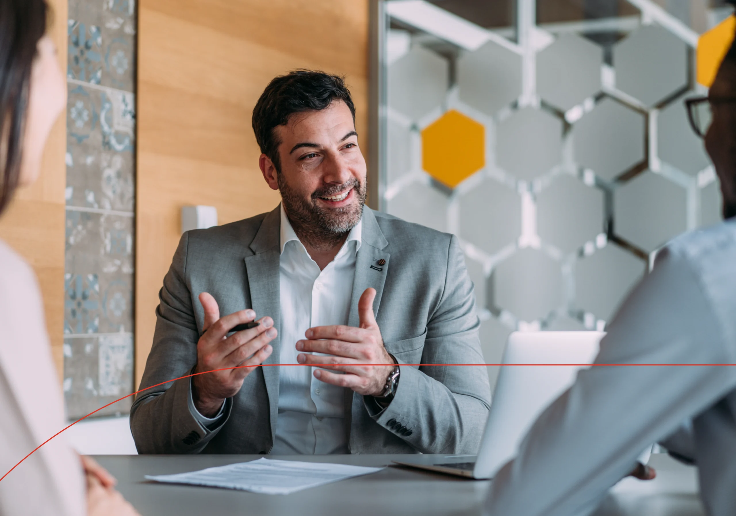 Man sits at table advising a client on the pros of having professional liability insurance.